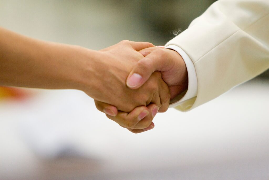 An intimate moment capturing a couple holding hands, symbolizing love and unity during a wedding ceremony.